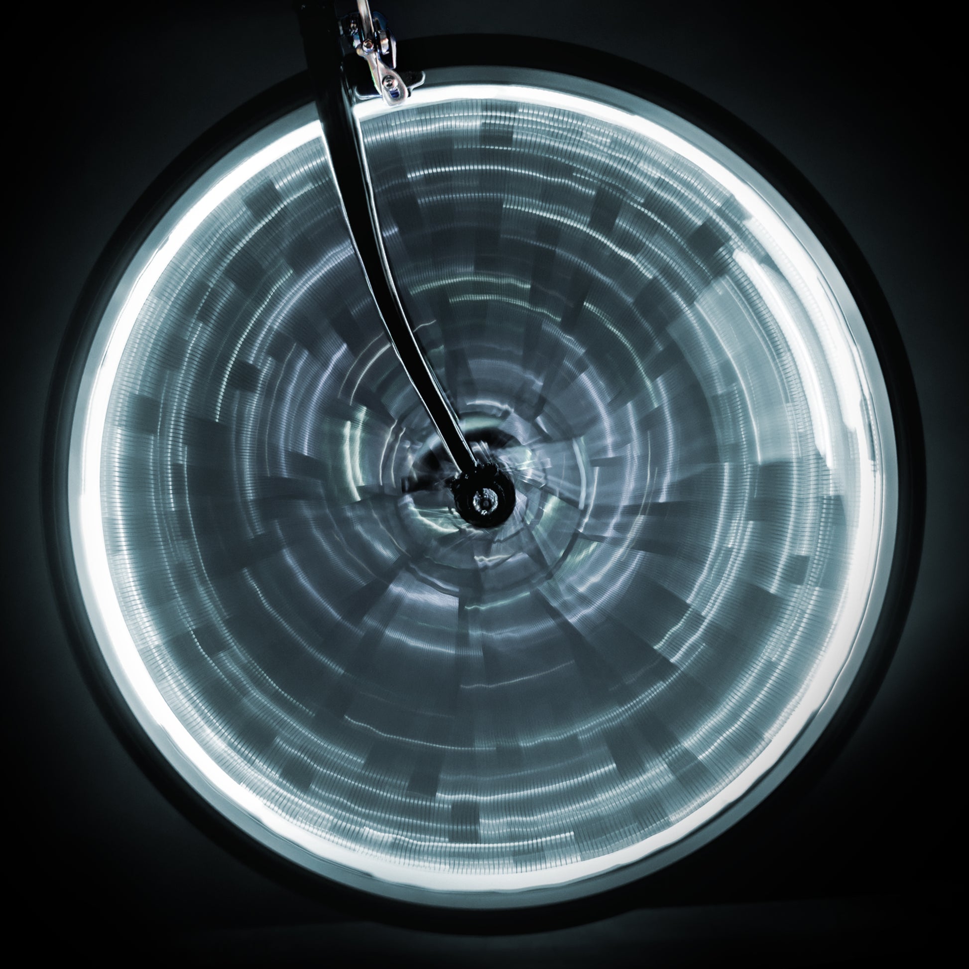Bright white LED lights on a spun bicycle wheel